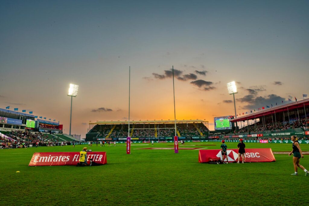 The sun sets over the pitch at the Dubai Sevens Rugby tournament.